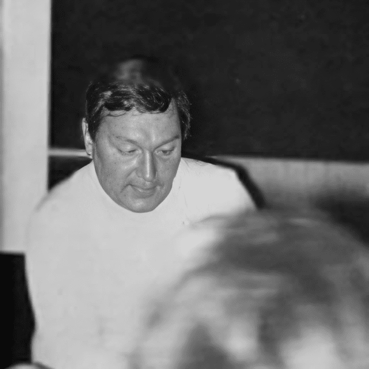 Individual presenting near a blackboard