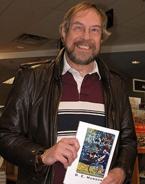 Person displaying a book indoors
