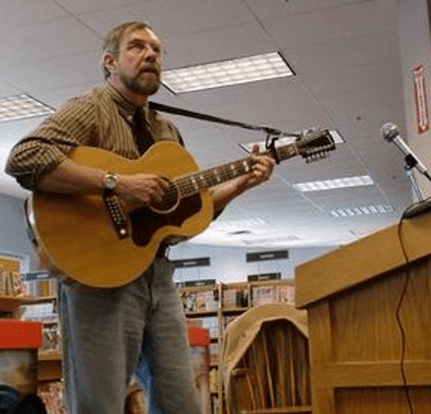 Man playing guitar at bookstore event