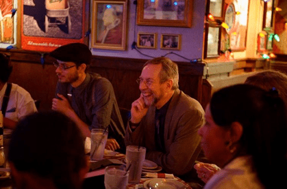 Friends laughing at a dinner gathering
