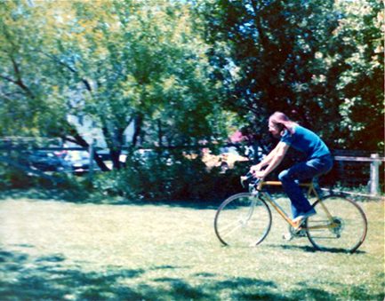 Person cycling in a sunny park