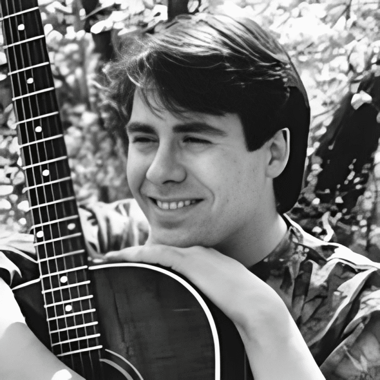 Man smiling with guitar outdoors