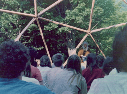 Group listening to speaker outside