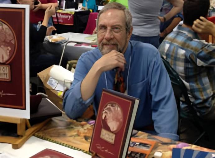 Man sitting at a book signing event