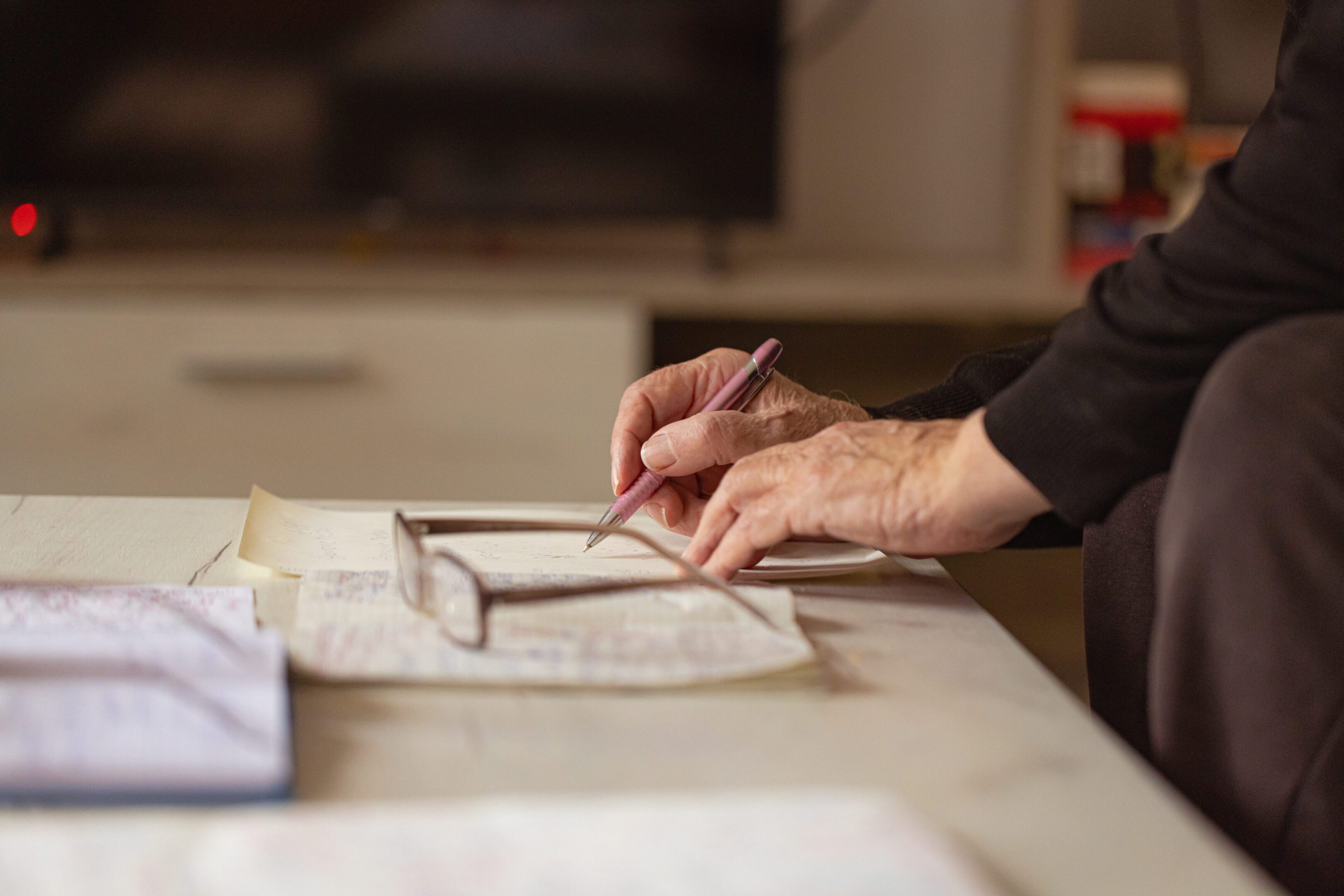 Hands holding a pen, writing