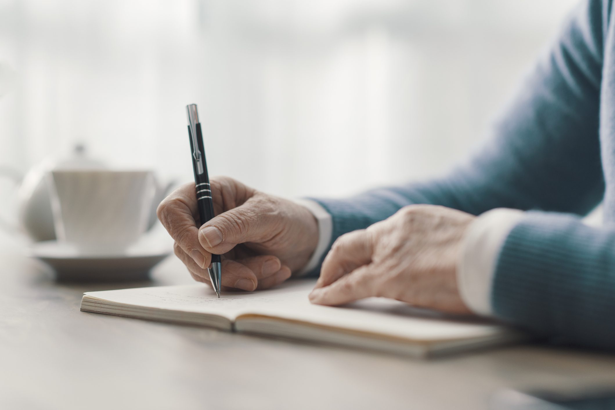 Writing in a notebook with pen